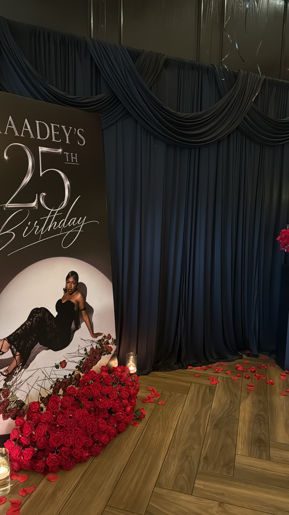 Black draped backdrop with roses and candles