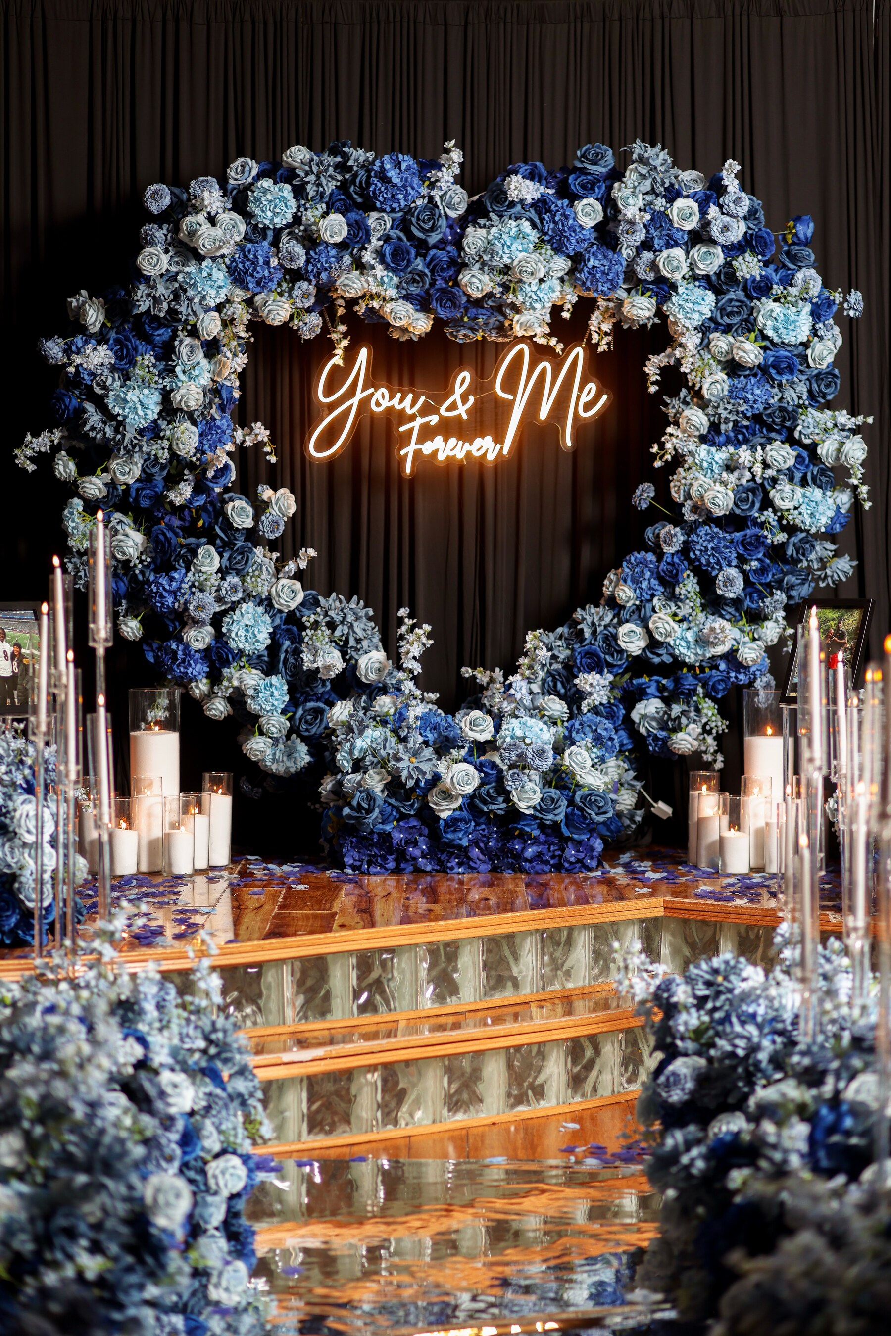 Close view of the royal blue floral heart backdrop and candlelight